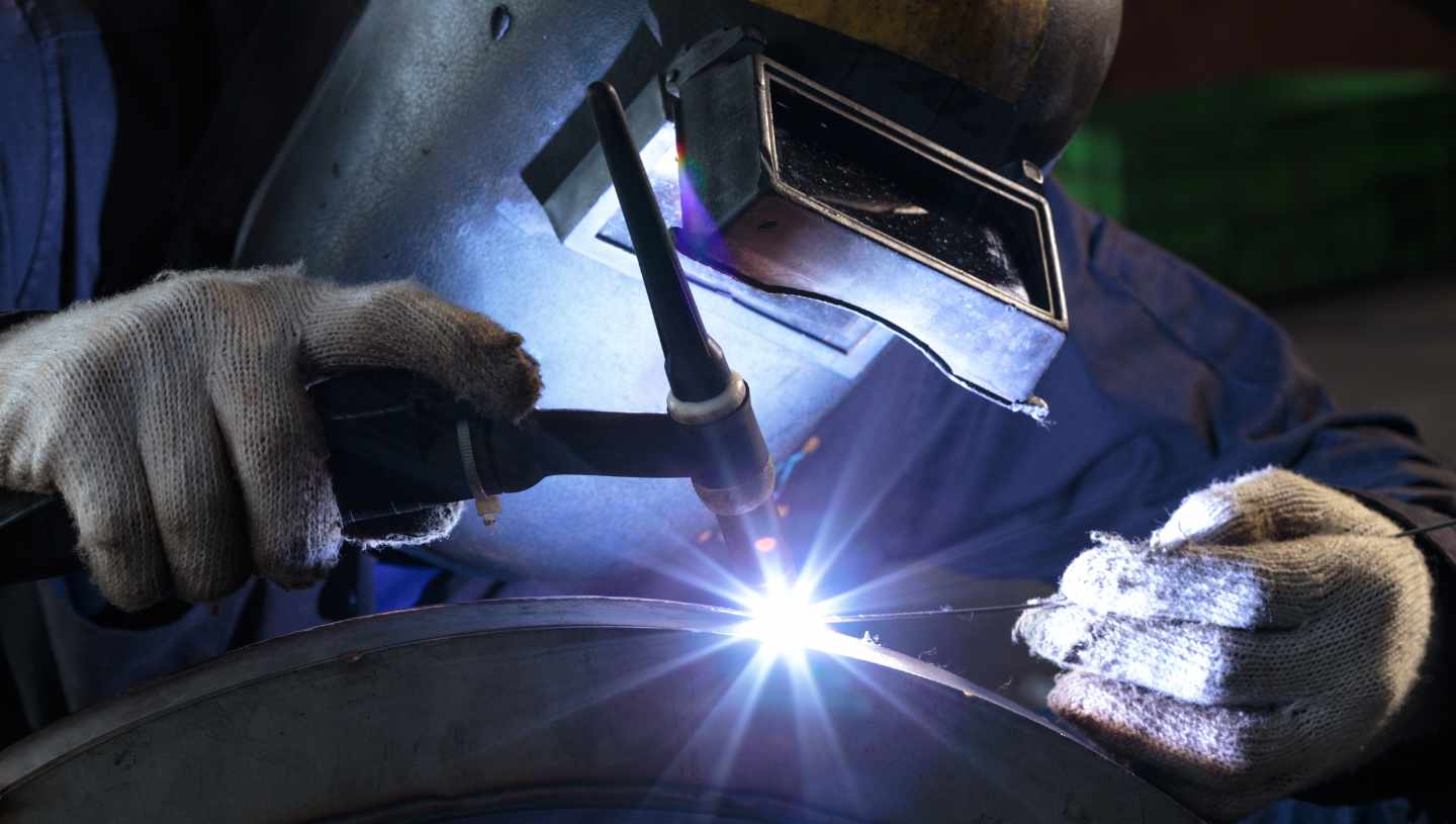 person welding a machine